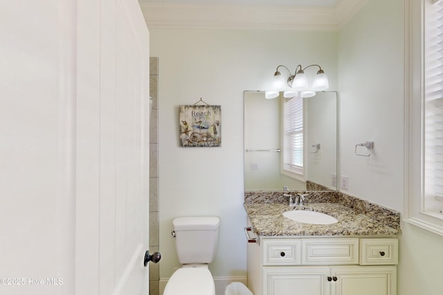 bathroom with ornamental molding, vanity, and toilet