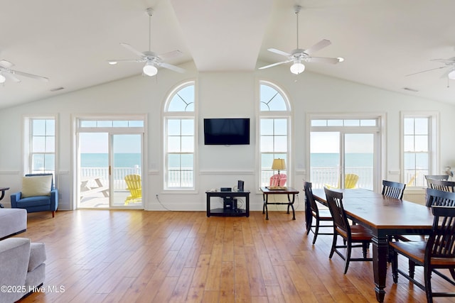 dining space featuring lofted ceiling, visible vents, light wood-style flooring, and a ceiling fan