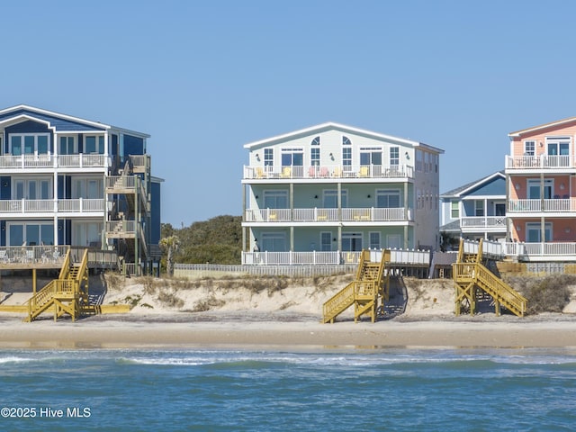 exterior space featuring a beach view and stairs