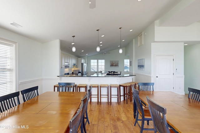 dining area featuring high vaulted ceiling, light wood-style flooring, recessed lighting, visible vents, and a ceiling fan