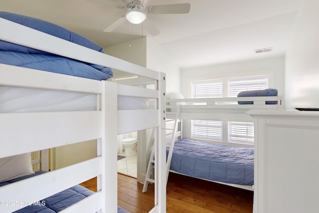 bedroom with visible vents, ceiling fan, and hardwood / wood-style flooring