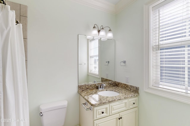 bathroom featuring crown molding, vanity, and toilet