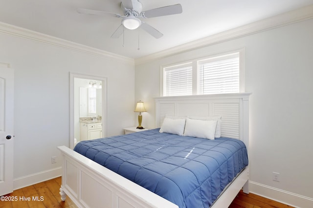 bedroom featuring baseboards, light wood finished floors, connected bathroom, and crown molding