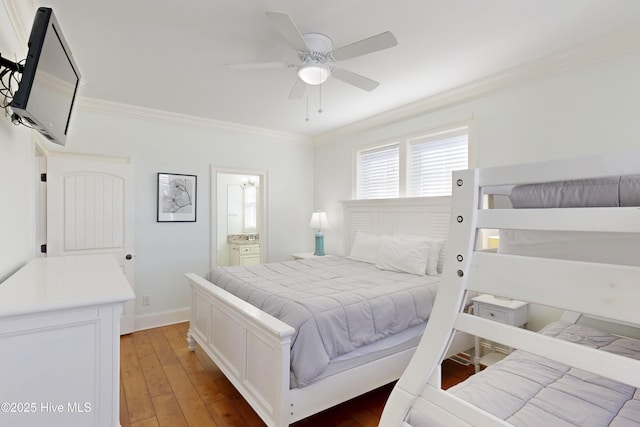 bedroom featuring baseboards, a ceiling fan, ensuite bathroom, crown molding, and light wood-style floors