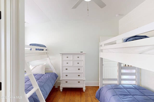 bedroom featuring a ceiling fan, baseboards, and hardwood / wood-style floors