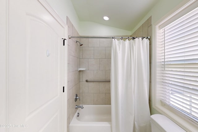 full bath featuring vaulted ceiling, shower / bathtub combination with curtain, and toilet