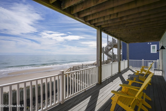 deck with a water view and a view of the beach