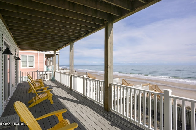 deck with a water view and a view of the beach