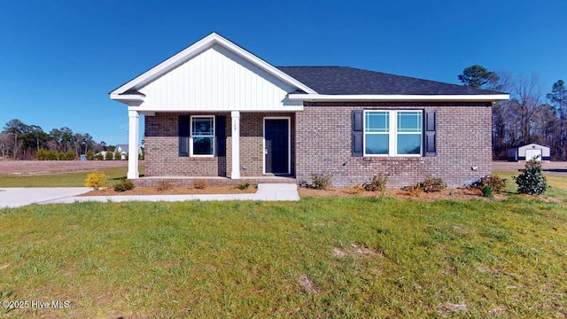 view of front of house featuring a front lawn and brick siding