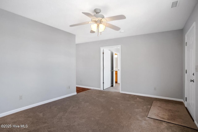 unfurnished bedroom with a ceiling fan, carpet, visible vents, and baseboards