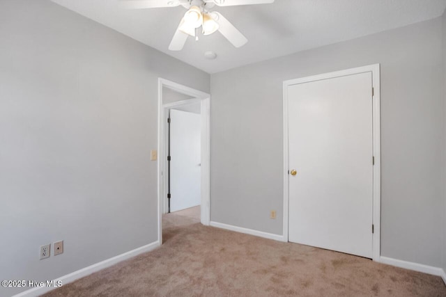 unfurnished bedroom featuring carpet flooring, ceiling fan, and baseboards