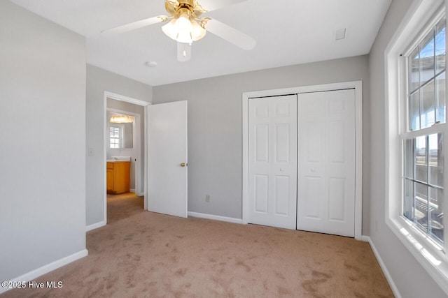 unfurnished bedroom with a closet, carpet, and baseboards