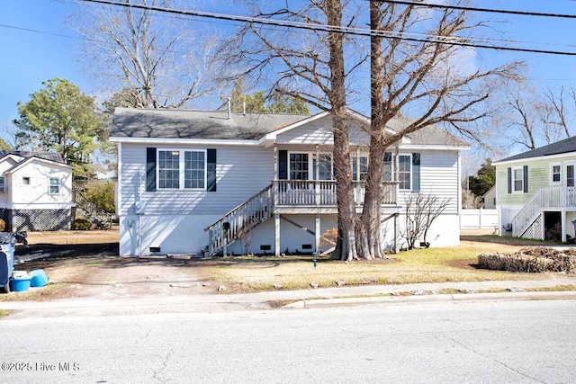 view of front of property with crawl space, fence, and stairs