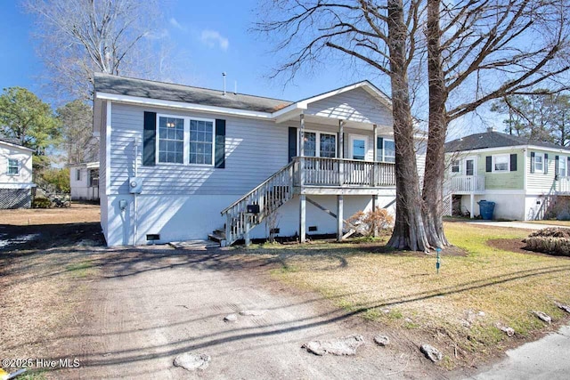 view of front of property featuring crawl space, stairway, and a front yard