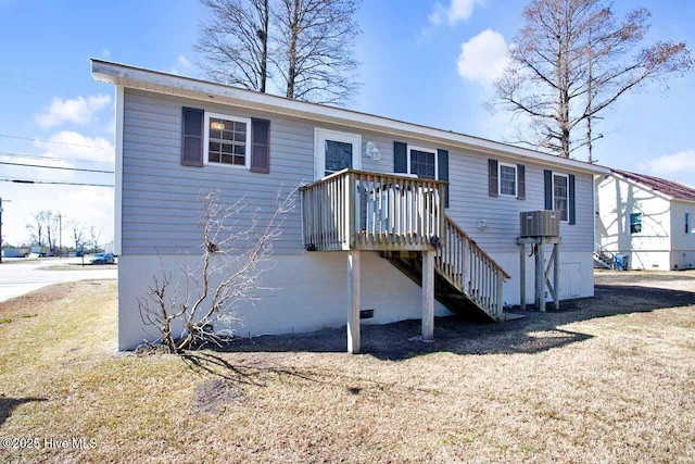 view of front of home featuring crawl space, a deck, stairs, and a front lawn