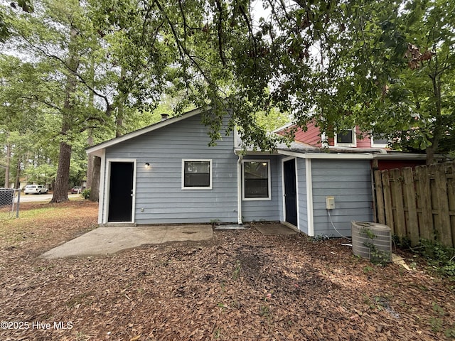 back of house with fence and central air condition unit
