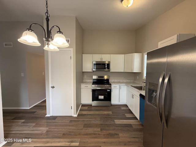 kitchen featuring dark wood-style floors, visible vents, white cabinetry, and stainless steel appliances