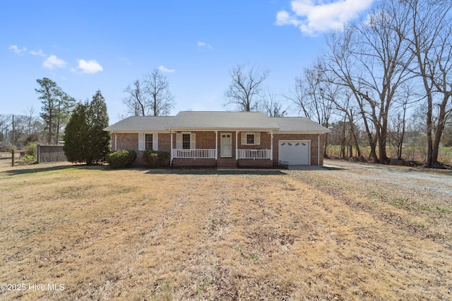 ranch-style house with an attached garage, covered porch, driveway, and brick siding