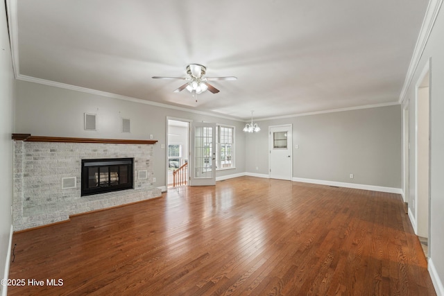 unfurnished living room featuring ornamental molding, a fireplace, wood finished floors, and baseboards