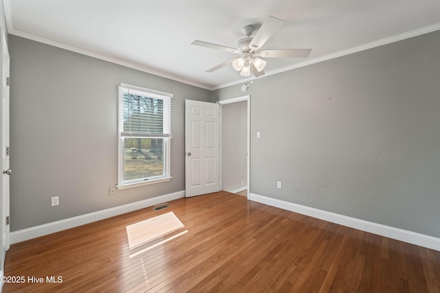 unfurnished bedroom featuring baseboards, ornamental molding, and hardwood / wood-style floors