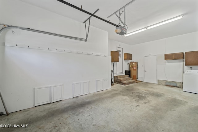 garage featuring a garage door opener, washer / clothes dryer, and gas water heater