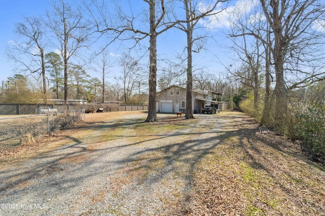 exterior space with a garage, fence, and driveway