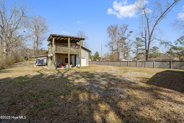 rear view of property with fence and an outdoor structure