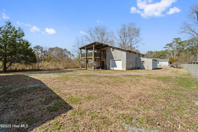 view of pole building featuring a yard, fence, and driveway