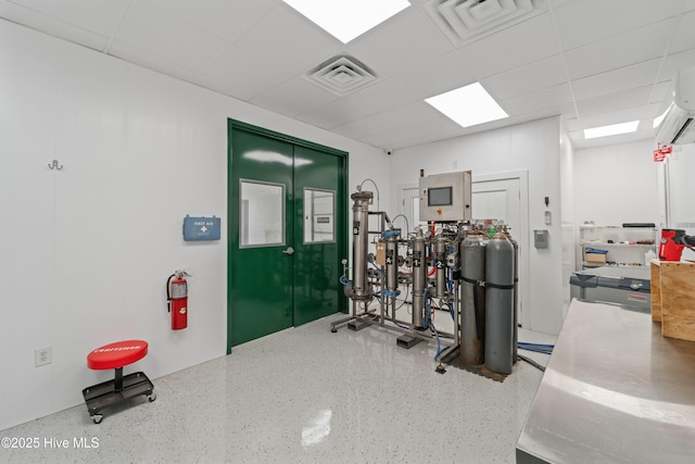 workout room with a drop ceiling and visible vents