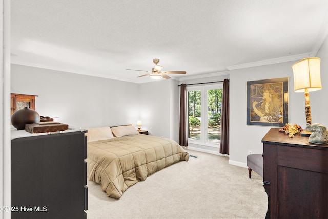 bedroom with a ceiling fan, carpet, ornamental molding, and baseboards