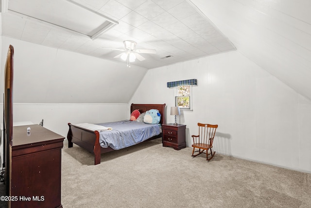 bedroom with a ceiling fan, carpet flooring, vaulted ceiling, and visible vents