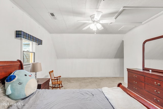 carpeted bedroom featuring lofted ceiling, visible vents, and a ceiling fan