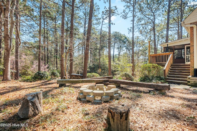 view of yard with a sunroom, stairs, and a wooden deck