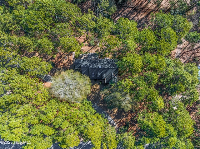 drone / aerial view featuring a view of trees