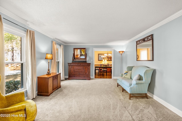 sitting room featuring ornamental molding, carpet, a textured ceiling, and baseboards