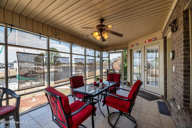 sunroom featuring wooden ceiling, plenty of natural light, and ceiling fan