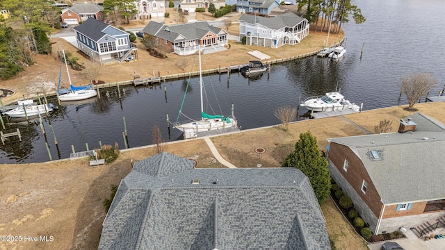 bird's eye view featuring a residential view and a water view