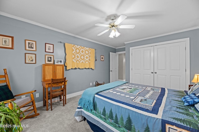 carpeted bedroom featuring baseboards, ceiling fan, a closet, and crown molding