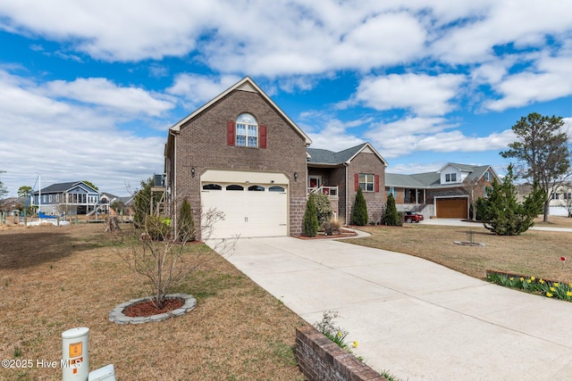 traditional-style house featuring a front lawn, concrete driveway, brick siding, and an attached garage