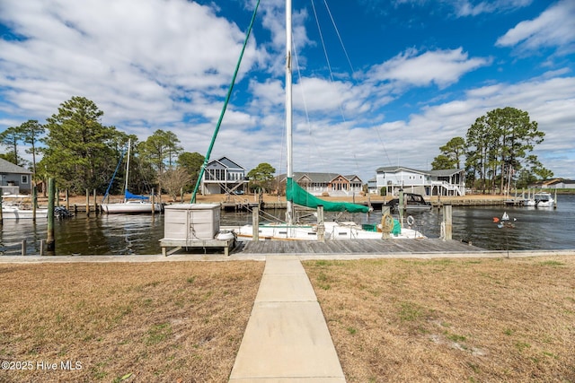 view of dock featuring a yard and a water view