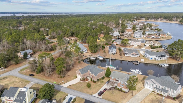 bird's eye view featuring a residential view, a water view, and a view of trees