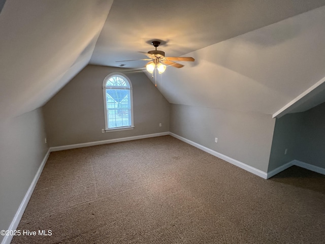 bonus room featuring vaulted ceiling, carpet floors, a ceiling fan, and baseboards