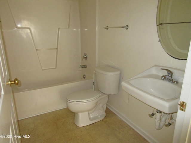 bathroom with bathtub / shower combination, a sink, and toilet