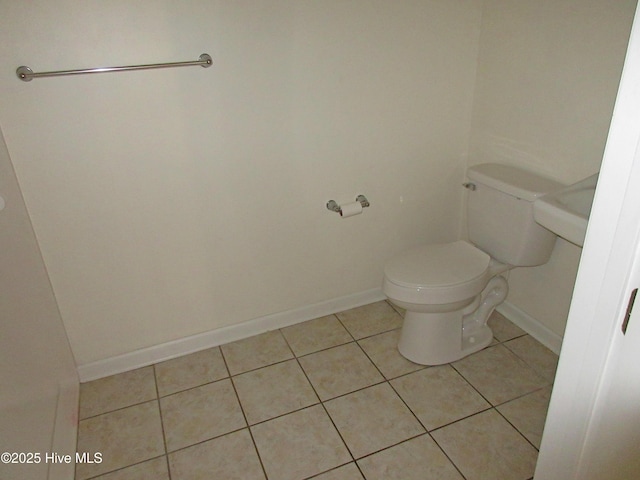 bathroom featuring baseboards, toilet, and tile patterned floors