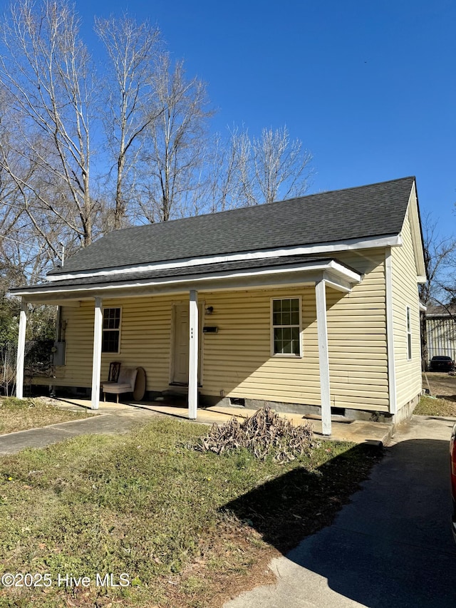 view of front of house with a shingled roof, crawl space, and a porch