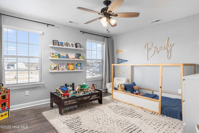 bedroom featuring visible vents, ceiling fan, baseboards, and wood finished floors