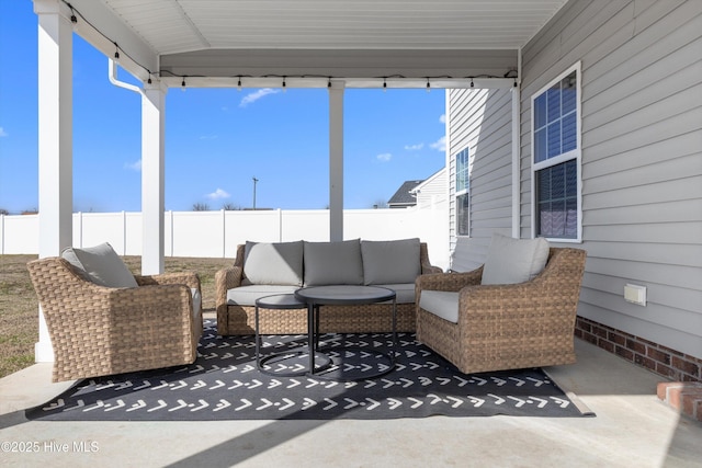 view of patio featuring fence and an outdoor hangout area