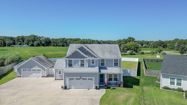 view of front of home featuring a garage, a front yard, and fence