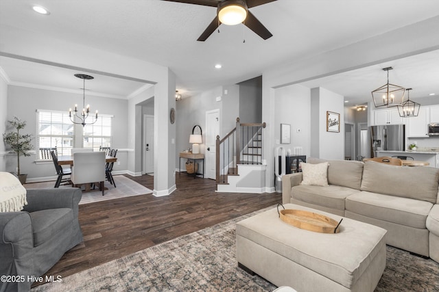 living area featuring dark wood-style floors, baseboards, recessed lighting, ornamental molding, and stairs