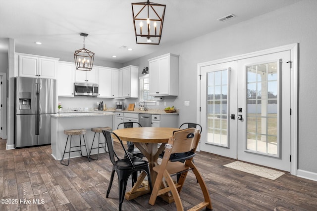 dining room with visible vents, recessed lighting, french doors, and dark wood-type flooring